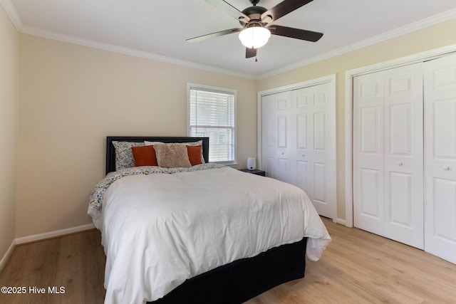 84 White Pine Rd, Lake Waccamaw, NC 28450 - bedroom featuring ornamental molding, light wood-style flooring, two closets, and a ceiling fan