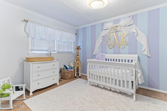 84 White Pine Rd, Lake Waccamaw, NC 28450 - bedroom featuring ornamental molding, wood finished floors, and a nursery area
