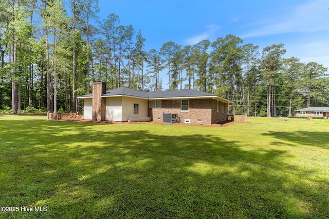 84 White Pine Rd, Lake Waccamaw, NC 28450 - rear view of house featuring a chimney, a lawn, brick siding, and crawl space