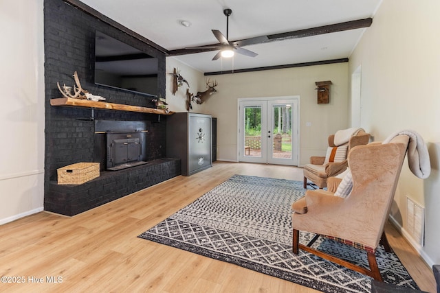 84 White Pine Rd, Lake Waccamaw, NC 28450 - living area with wood finished floors, a ceiling fan, and a brick fireplace