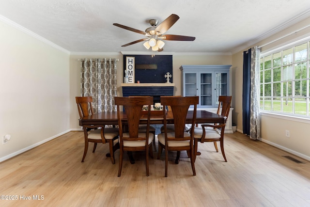 84 White Pine Rd, Lake Waccamaw, NC 28450 - dining area with light wood-style flooring, healthy amount of natural light, crown molding, and ceiling fan