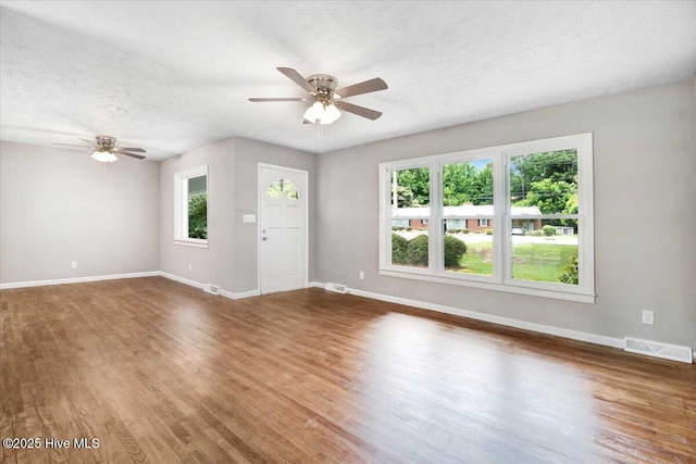 527 W College St, Warsaw, NC 28398 - unfurnished living room with ceiling fan, wood finished floors, and a textured ceiling