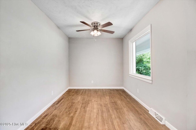 527 W College St, Warsaw, NC 28398 - empty room with light wood-style flooring, ceiling fan, and a textured ceiling