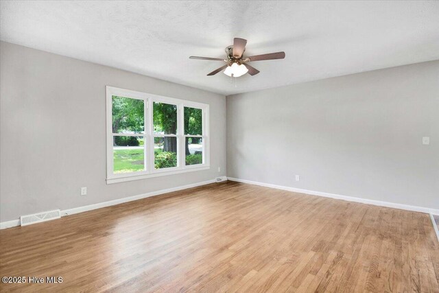 527 W College St, Warsaw, NC 28398 - empty room featuring ceiling fan and light wood-style floors