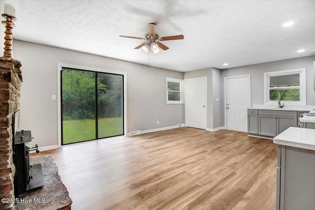 527 W College St, Warsaw, NC 28398 - unfurnished living room featuring a ceiling fan, light wood-type flooring, and recessed lighting