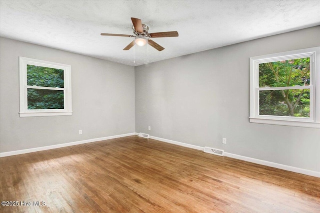 527 W College St, Warsaw, NC 28398 - spare room featuring wood finished floors, a ceiling fan, and a textured ceiling