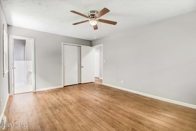 527 W College St, Warsaw, NC 28398 - unfurnished bedroom featuring light wood-style flooring, ensuite bathroom, ceiling fan, and a closet