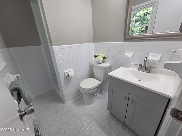 527 W College St, Warsaw, NC 28398 - full bath with vanity, a wainscoted wall, tile walls, tile patterned flooring, and a shower