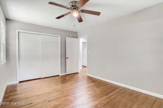 527 W College St, Warsaw, NC 28398 - unfurnished bedroom with wood finished floors, a closet, and a ceiling fan