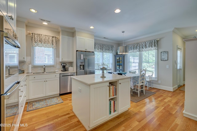 4929 Lake Renaissance Cir, Wilmington, NC 28409 - kitchen featuring appliances with stainless steel finishes, light wood finished floors, light countertops, recessed lighting, and decorative backsplash