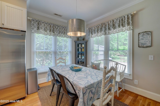 4929 Lake Renaissance Cir, Wilmington, NC 28409 - dining space with ornamental molding, light wood-style flooring, and healthy amount of natural light