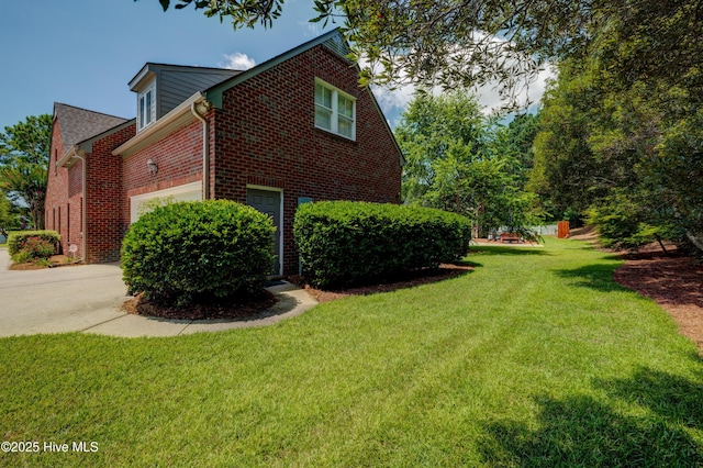 4929 Lake Renaissance Cir, Wilmington, NC 28409 - view of side of home with brick siding, driveway, a yard, and a garage