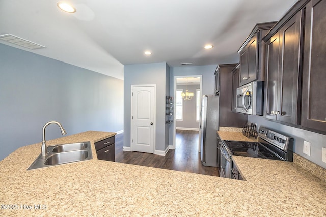 368 Lehigh Rd, Wilmington, NC 28412 - kitchen featuring appliances with stainless steel finishes, dark brown cabinets, dark wood finished floors, light countertops, and recessed lighting