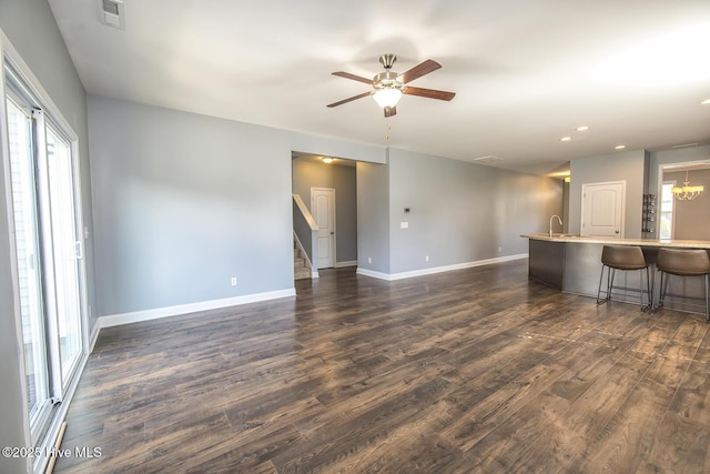 368 Lehigh Rd, Wilmington, NC 28412 - unfurnished living room featuring healthy amount of natural light, dark wood-style floors, stairway, and recessed lighting