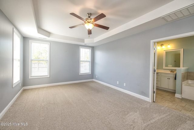 368 Lehigh Rd, Wilmington, NC 28412 - spare room with light colored carpet, a raised ceiling, and ceiling fan