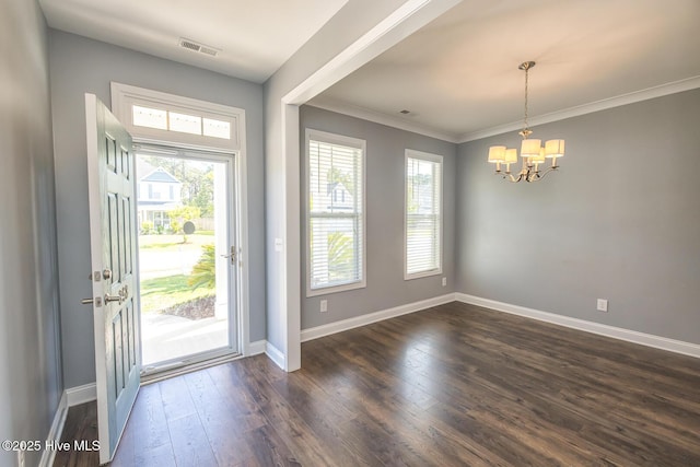 368 Lehigh Rd, Wilmington, NC 28412 - entrance foyer with healthy amount of natural light, a chandelier, dark wood-type flooring, and ornamental molding
