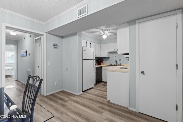 1004 Carolina Beach Ave S Unit A4, Carolina Beach, NC 28428 - kitchen featuring freestanding refrigerator, dishwasher, crown molding, light countertops, and light wood-type flooring