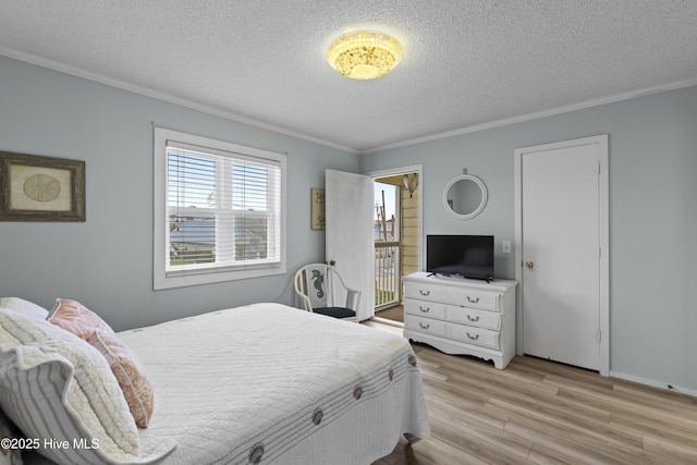 1004 Carolina Beach Ave S Unit A4, Carolina Beach, NC 28428 - bedroom featuring a textured ceiling, light wood-style flooring, and crown molding