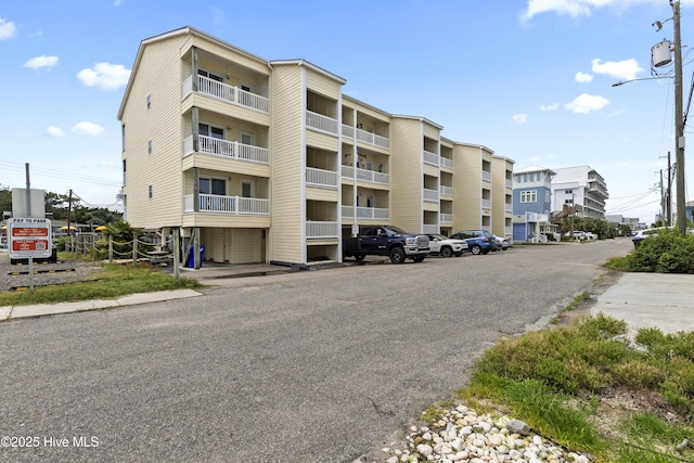 1004 Carolina Beach Ave S Unit A4, Carolina Beach, NC 28428 - view of apartment building / complex featuring uncovered parking