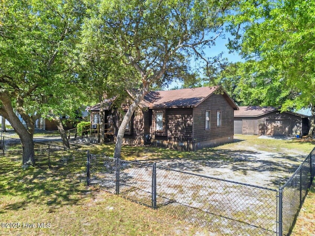 163 NW 9th St, Oak Island, NC 28465 - view of front of home with an outdoor structure, driveway, and a garage