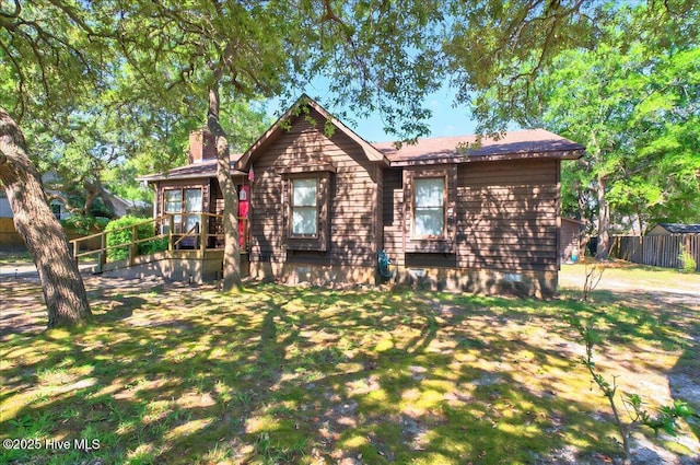 163 NW 9th St, Oak Island, NC 28465 - view of front facade featuring a chimney