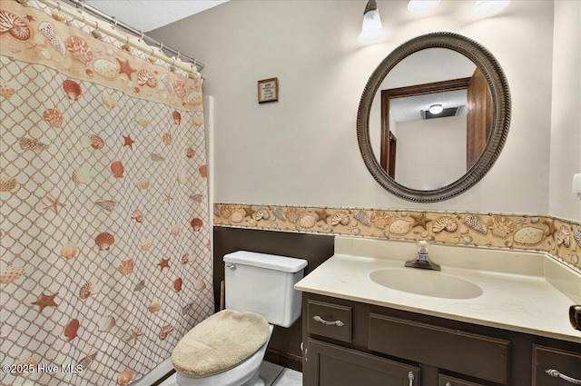 163 NW 9th St, Oak Island, NC 28465 - bathroom featuring vanity, wainscoting, and a shower with curtain