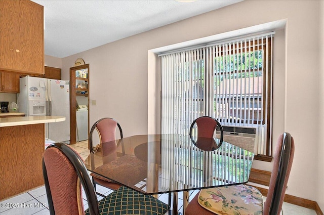 163 NW 9th St, Oak Island, NC 28465 - dining space featuring washer / clothes dryer and light tile patterned flooring