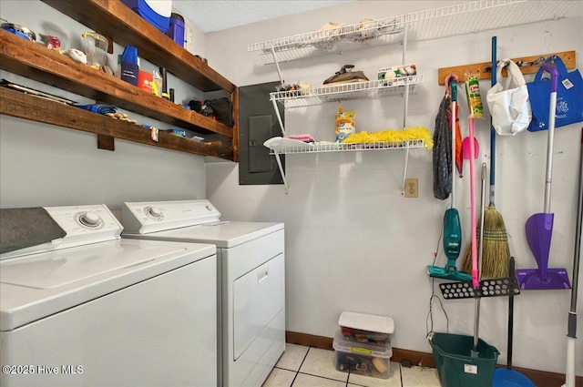 163 NW 9th St, Oak Island, NC 28465 - laundry room with washer and clothes dryer, electric panel, and light tile patterned floors