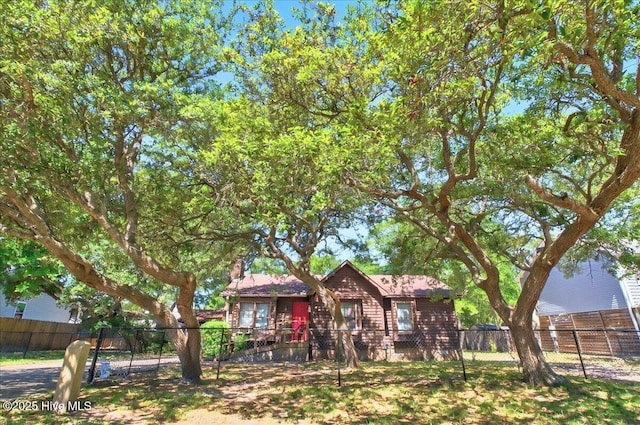 163 NW 9th St, Oak Island, NC 28465 - rear view of house featuring a fenced front yard