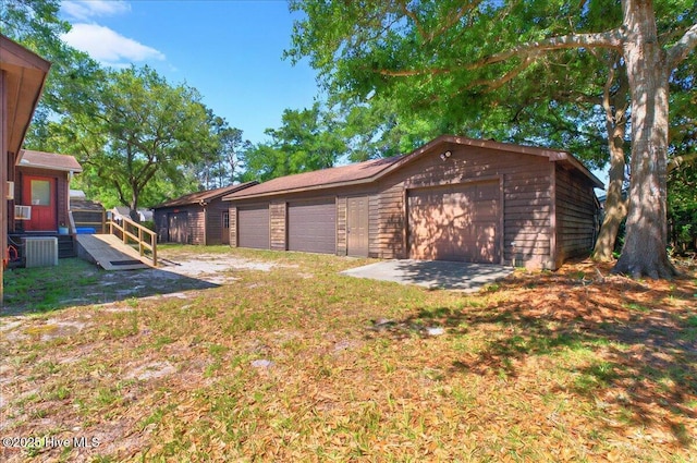 163 NW 9th St, Oak Island, NC 28465 - view of yard featuring a garage and an outbuilding