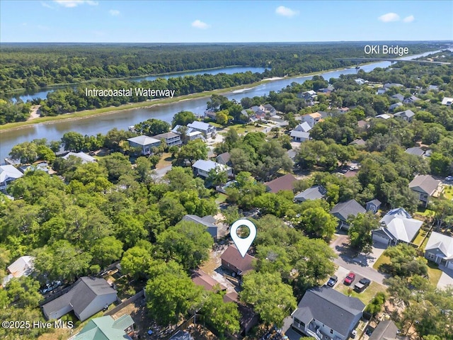 163 NW 9th St, Oak Island, NC 28465 - aerial perspective of suburban area featuring a forest and a nearby body of water
