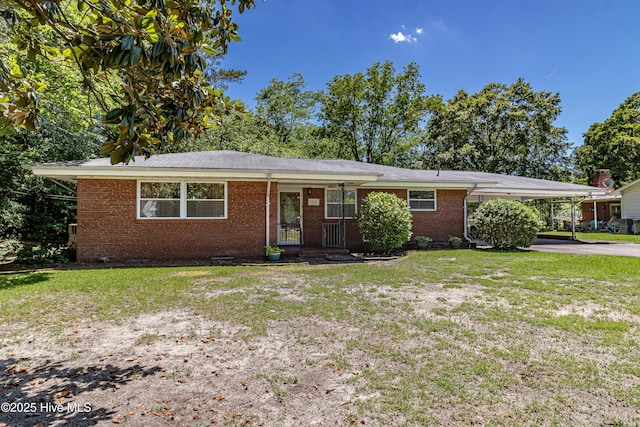 106 E New Hope Rd, Goldsboro, NC 27534 - ranch-style house with brick siding, a front lawn, an attached carport, and driveway