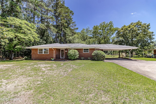 106 E New Hope Rd, Goldsboro, NC 27534 - view of front of house with driveway, a carport, brick siding, and a front yard