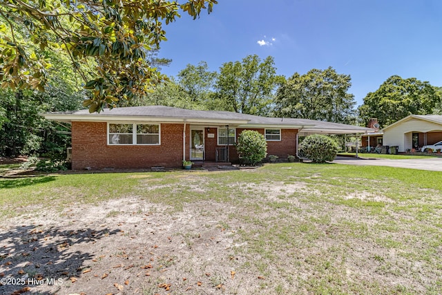 106 E New Hope Rd, Goldsboro, NC 27534 - ranch-style home featuring concrete driveway, brick siding, a front lawn, and an attached carport