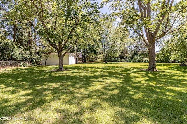 106 E New Hope Rd, Goldsboro, NC 27534 - view of yard with a storage shed and view of wooded area