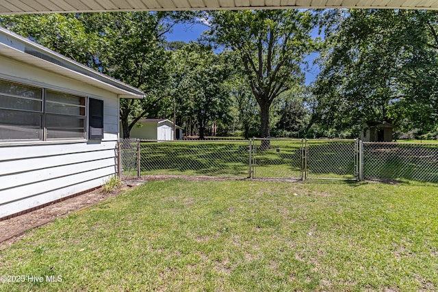 106 E New Hope Rd, Goldsboro, NC 27534 - view of yard featuring a gate, a storage shed, and view of scattered trees