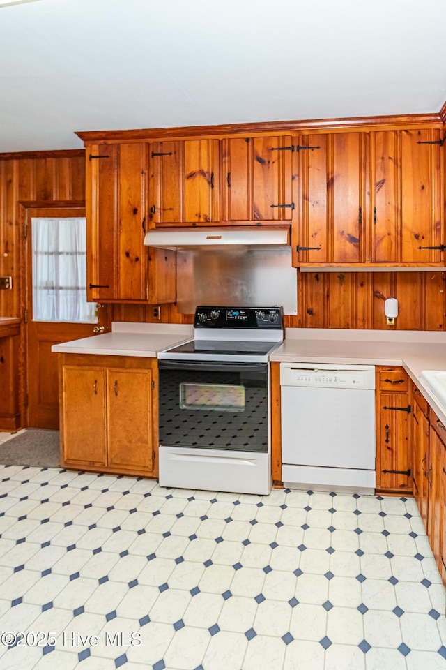 106 E New Hope Rd, Goldsboro, NC 27534 - kitchen with electric range, white dishwasher, ventilation hood, light floors, and wood walls