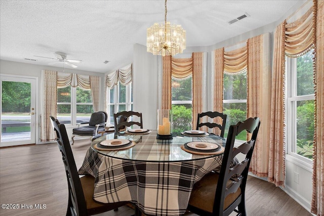 1610 Winding Way SW, Ocean Isle Beach, NC 28469 - dining space with wood finished floors, a chandelier, a textured ceiling, and ceiling fan