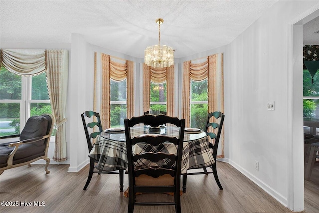 1610 Winding Way SW, Ocean Isle Beach, NC 28469 - dining area with a chandelier, wood finished floors, plenty of natural light, and a textured ceiling
