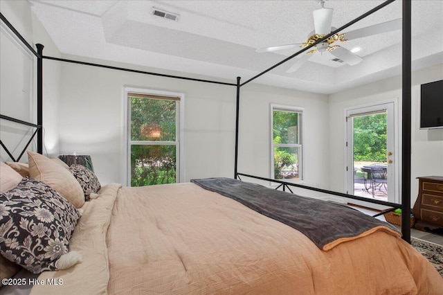 1610 Winding Way SW, Ocean Isle Beach, NC 28469 - bedroom featuring a tray ceiling, access to outside, and ceiling fan