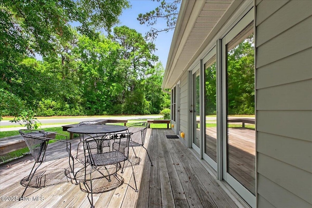1610 Winding Way SW, Ocean Isle Beach, NC 28469 - deck featuring outdoor dining area and view of wooded area