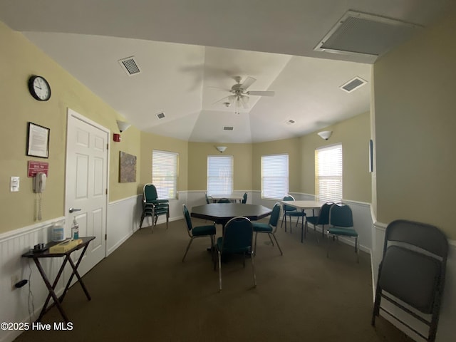 188 Edgewater Cir, Sunset Beach, NC 28468 - dining space with dark colored carpet, a ceiling fan, and a wainscoted wall