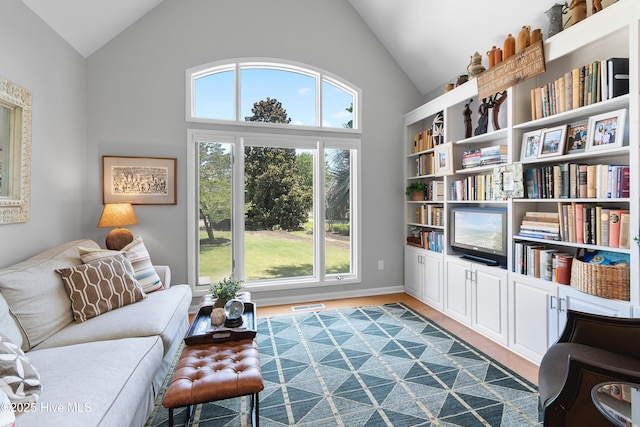 188 Edgewater Cir, Sunset Beach, NC 28468 - sitting room with high vaulted ceiling and wood finished floors