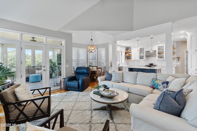 188 Edgewater Cir, Sunset Beach, NC 28468 - living room with light wood finished floors, french doors, high vaulted ceiling, and recessed lighting