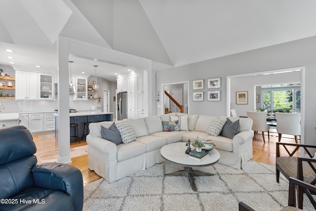 188 Edgewater Cir, Sunset Beach, NC 28468 - living area featuring light wood-type flooring, vaulted ceiling, recessed lighting, and ornate columns