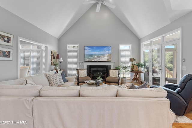 188 Edgewater Cir, Sunset Beach, NC 28468 - living area featuring a glass covered fireplace, ceiling fan, high vaulted ceiling, and wood finished floors