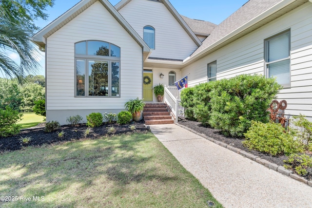 188 Edgewater Cir, Sunset Beach, NC 28468 - view of front of property with a front yard and roof with shingles