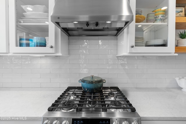 188 Edgewater Cir, Sunset Beach, NC 28468 - kitchen with wall chimney exhaust hood, range, tasteful backsplash, white cabinets, and light stone countertops