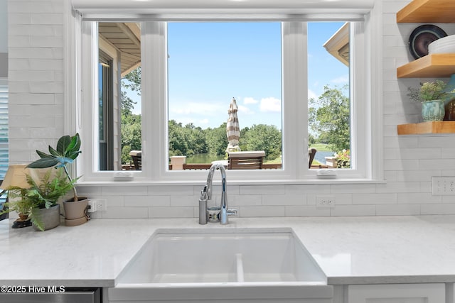 188 Edgewater Cir, Sunset Beach, NC 28468 - kitchen with backsplash, open shelves, dishwasher, and white cabinets