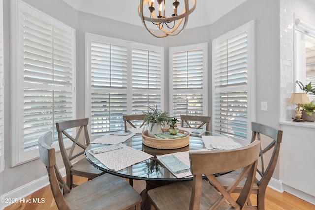 188 Edgewater Cir, Sunset Beach, NC 28468 - dining room with a chandelier and light wood-style flooring